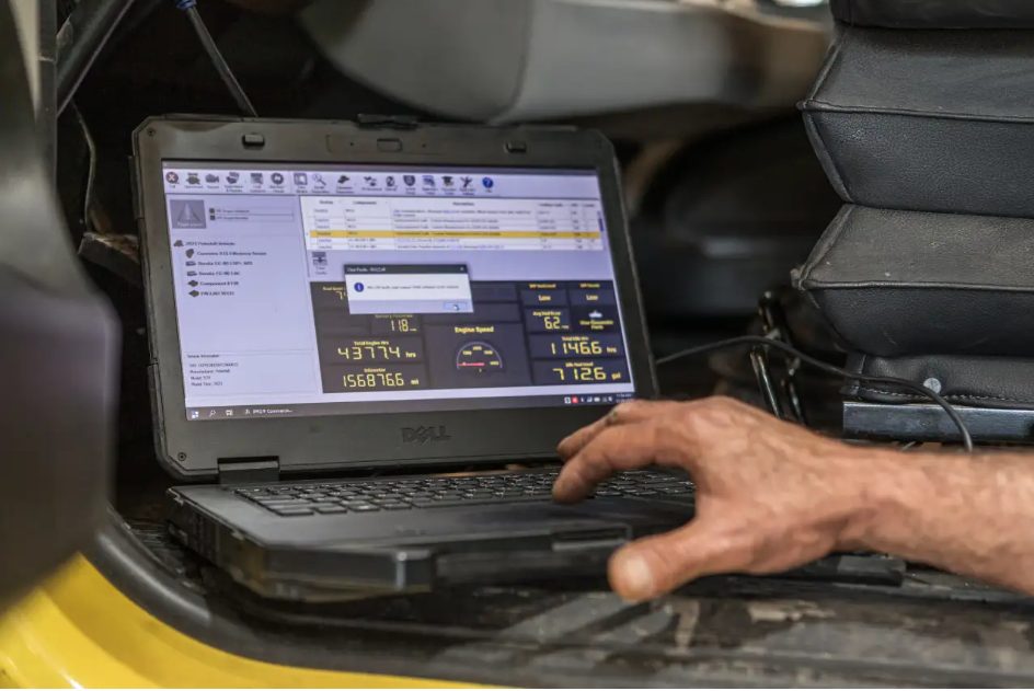 Technician reviewing live fuel system data on a laptop during a Duramax diagnostic